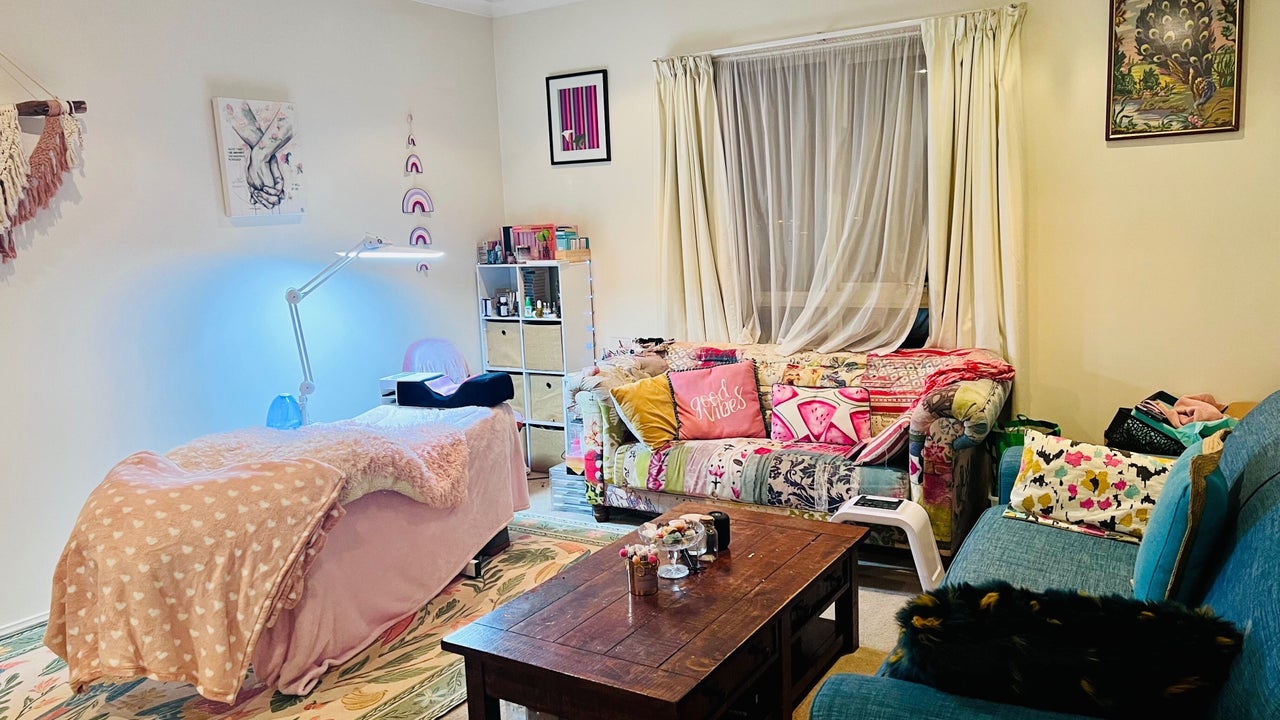 Inside Shell’s Beauty Temple: a treatment bed with a pink blanket, patchwork couch and soft lamp